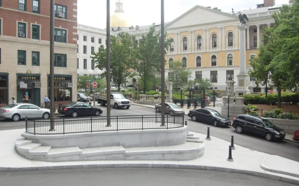 A clean and respectable remake of an old and decrepit traffic island where the flagpoles threatened to keel over.